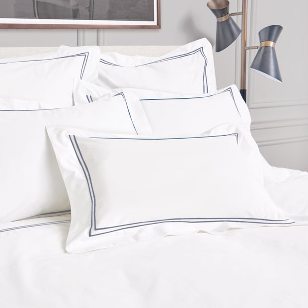 Legacy Ink pillowcases styled together in a modern bedroom setting.