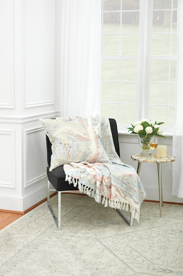 decorative pillow and throw with marble design on a chair