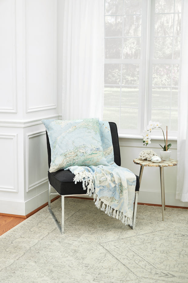 decorative pillow and throw with marble design on a chair