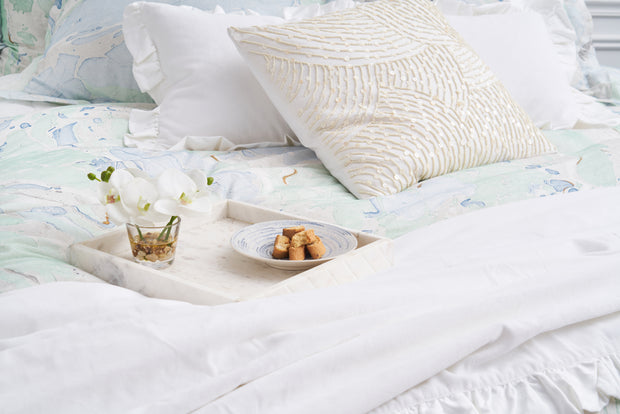 blue and green marble designed duvet cover with white pillows and a sequin pillow