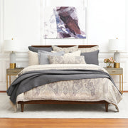 100% cotton jacquard woven coverlet with tan paisley design and matching accessories on a bed