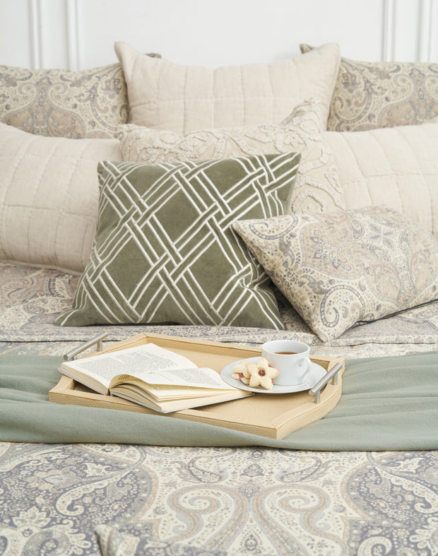 100% cotton jacquard woven coverlet with tan paisley design and matching accessories on a bed