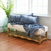 navy throw featuring a paisley pattern displayed on a bench and paired with a matching pillows