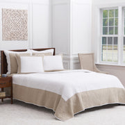 tan and white quilt and bedding accessories