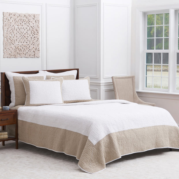 tan and white quilt and bedding accessories