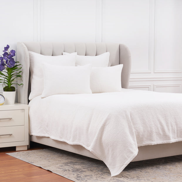 white coverlet bedding with matching pillow shams