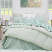 light green coverlet bedding with matching pillows paired with a soft green duvet cover