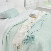 eva sea glass collection styled on a bed